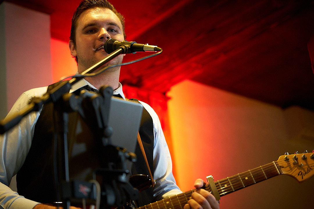 Tim Lukey singing and playing electric guitar live
